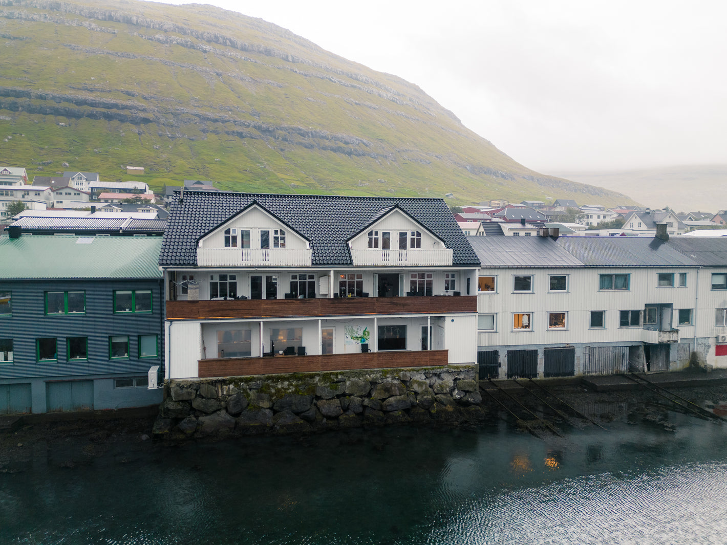 House next to the sea in Klaksvik, Faroe Islands taken with a drone